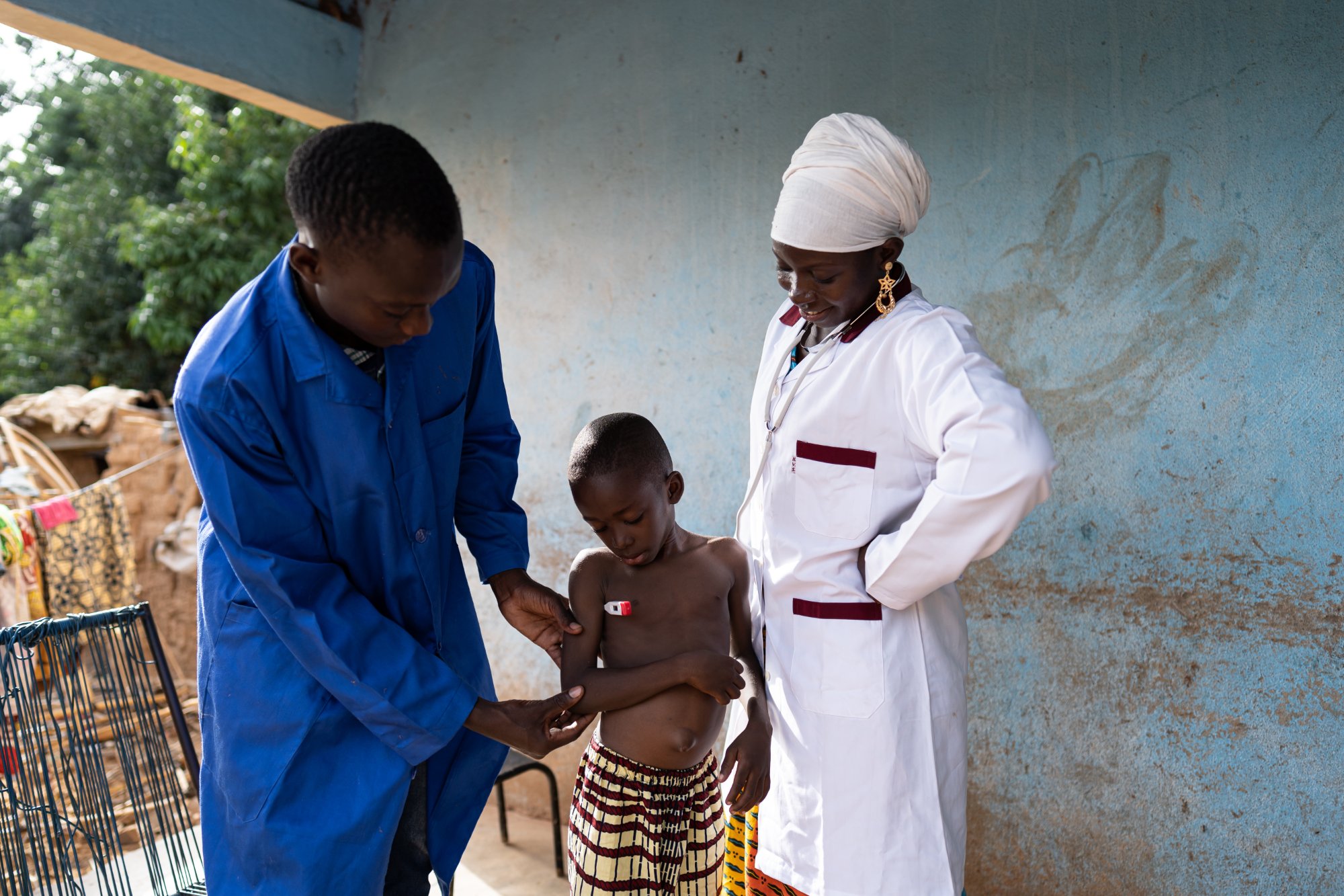 Community health worker examining a child